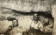 New Zealand troops share a pipe in a dugout at the Signalling Station on No 2 Outpost.